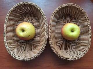 apples in wooden baskets on wooden table