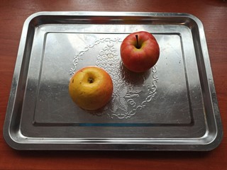 apples on iron tray on wooden table