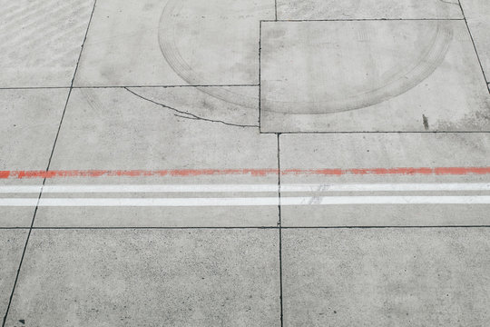 View from above of Road with white and red lines on markings on the asphalt ground Cement floor in runway airport.
