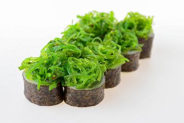 Seaweed chuka sushi rolls with rice isolated on white background. Japanese cuisine. Eight sushi set with seaweed salad.