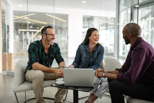 Candid Real Meeting Of Diverse Successful Business Team Smiling And Socializing