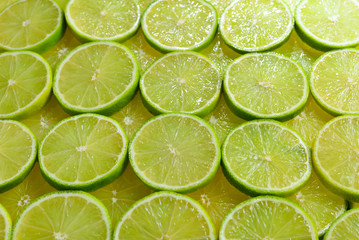 Fresh lime slices as a background.