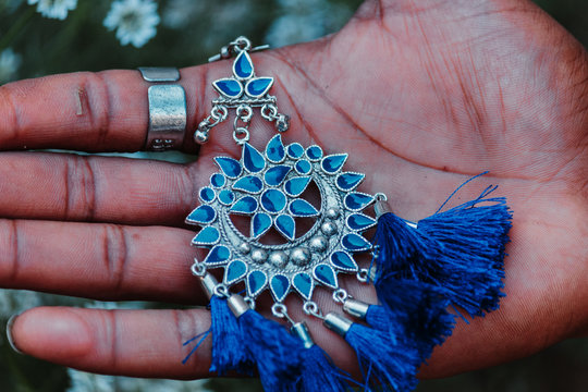 Closeup shot of an ear ring in hand