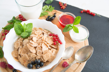 Healthy tasty breakfast multigrain wholewheat healthy cereals with strawberries, raspberries, black currants and red currants.