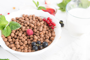 breakfast Healthy tasty breakfast chocolate balls with strawberries, raspberries, black currants and red currants.