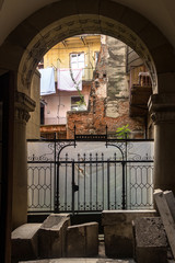 In the courtyard from the balconies hanging clothes. The lifestyle of a small town. Historical staff.