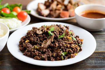 Northern Thai food, spicy minced pork salad (Larb Moo Kua) eating with sticky rice and grilled intestine