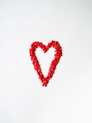 Red sugar sprinkles heart. Sugar sprinkle hearts, decoration for cake and bakery, symbol of love on valentines day on white background. Top view