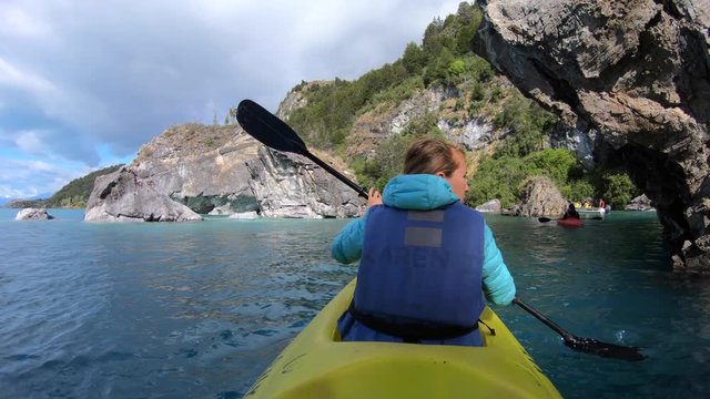 Woman explores limestone rock formation and swims inside the cave (Marble Caves) on the lake General Carrera in Chilean Patagonia, Aysen region, Chile