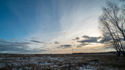 Beautiful setting sun over frozen field