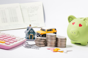 Saving money for house and car that stack coins and Passbook with calculator and piggy bank