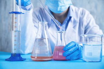Girl working with flask in a laboratory.