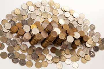 Many monetary coins lie and stand in columns depicting monetary wealth.