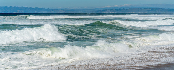 Beautiful seascape. Blue waves breaking on the shore.