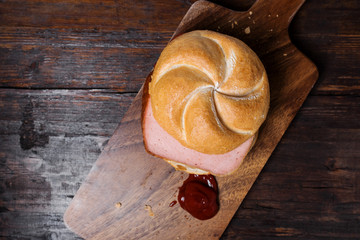 Bread roll with sausage and ketchup