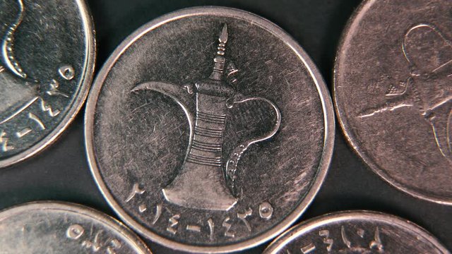 One UAE dirhams isolated on black background, macro shot of United Arab Emirates one dirham isolated , Coffee pot " dallah " graphic details from UAE dirham coin
