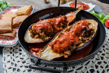 Baked melanzani filled with cheese and vegetables served in a rustic pan