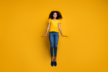 Fototapeta na wymiar Full length body size view of her she nice-looking attractive lovely cheerful cheery funny wavy-haired girl jumping up having fun isolated on bright vivid shine vibrant yellow color background