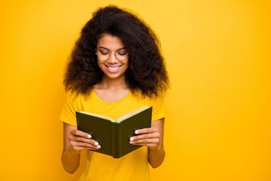 Close-up portrait of her she nice attractive lovely brainy cheerful cheery wavy-haired girl reading novel visit library isolated over bright vivid shine vibrant yellow color background