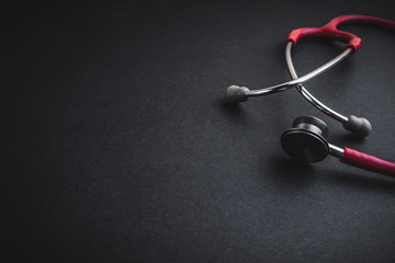 Stethoscope on black background. Selective focus and copy space