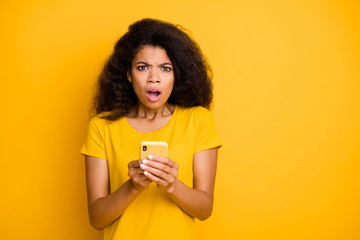 Close-up portrait of her she nice attractive lovely worried desperate confused wavy-haired girl using gadget smm marketing fail isolated over bright vivid shine vibrant yellow color background