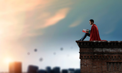 Super hero on roof. Mixed media