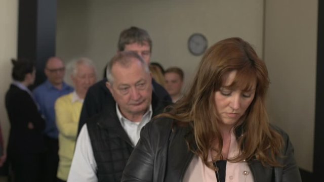 People Queue or Standing in line. Indoors. Queueing up. Waiting.