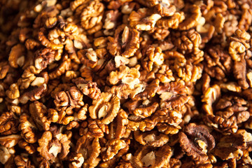 Closeup of big shelled walnuts pile. Walnuts close-up. Ripe and tasty peeled nuts big shelled walnuts pile.