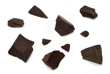 Cracked chocolates / broken chocolate chips or chocolate parts top view isolated on white background