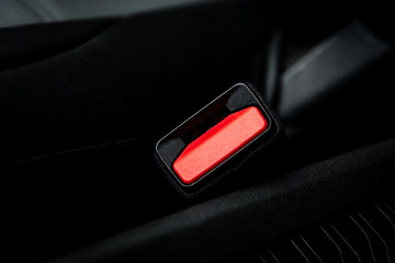 Seat belt in black car interior.
