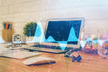 Financial graph colorful drawing and table with computer on background. Double exposure. Concept of...