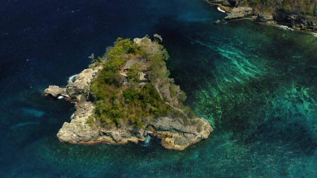 Aerial drone flight over small island with house at Indian ocean, Bali, Indonesia, 4k.
