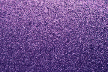 Grainy purple shiny background. Fabric sparkle, texture. Gradient on textile, clothes. Glitter wall. Material pattern, metallic tinsel, decoration.