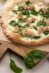 Delicious fresh pizza on table. Rustic pizza with minced meat cheese, basil on top. pizza with meat and basil. Homemade delicious italian pizza on wooden table for dinner. Italian cuisine.
