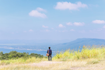 Young man standing to looking at the future, success concept.