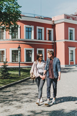 Fototapeta na wymiar Travel couple, Romantic Destinations, Weekend Getaways, honeymoon for Couples. Happy young travellers woman and man with backpacks walks the streets of the city