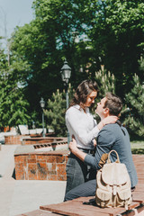 Travel couple, Romantic Destinations, Weekend Getaways, honeymoon for Couples. Happy young travellers woman and man with backpacks walks the streets of the city