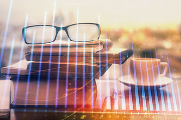 Financial graph hologram with glasses on the table background. Concept of business. Double exposure.