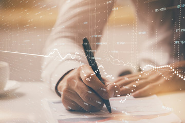 Financial trading chart multi exposure with man desktop background.