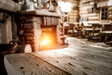 Fototapeta na wymiar Desk of free space and blurred background of fireplace 