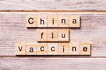 China flu vaccine word written on wood block. China flu vaccine text on wooden table for your desing, coronavirus concept top view