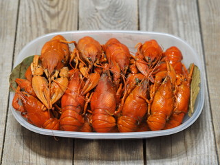 Red boiled crayfish on a wooden ancient background.