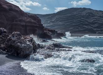 Fototapeta na wymiar The surf on volcanic black beach El Golfo, island Lanzarote