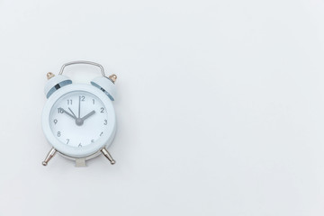 Obraz na płótnie Canvas Simply flat lay design Ringing twin bell vintage classic alarm clock Isolated on white background. Rest hours time of life good morning night wake up awake concept. Flat lay top view copy space.