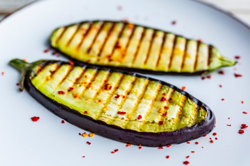 Grilled eggplant slices on a plate.