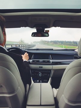 View From Back Seat Of Man Driving Car