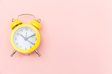 Ringing twin bell vintage classic alarm clock Isolated on pink colourful trendy pastel background....