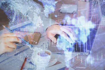 Forex graph with businessman working on computer in office on background. Concept of hardworking. Multi exposure.