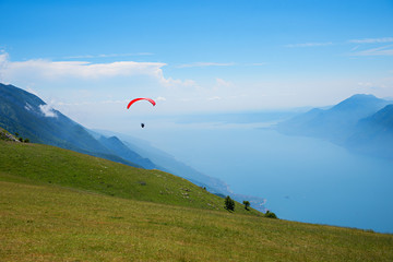 Monte Baldo mountain italy, paraglider floating over lake garda.