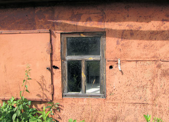 Old window in a rustic barn. Old wooden window.                               